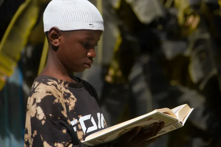 Boy reading the Quran outdoors