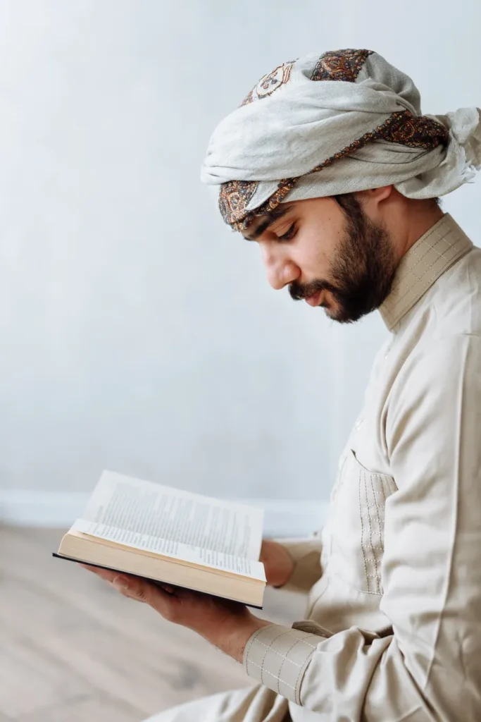 Adult man reading the Quran at home