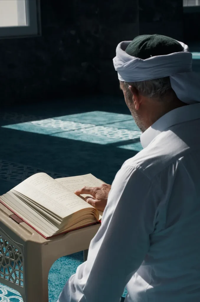 Adult man reading the Quran in a mosque