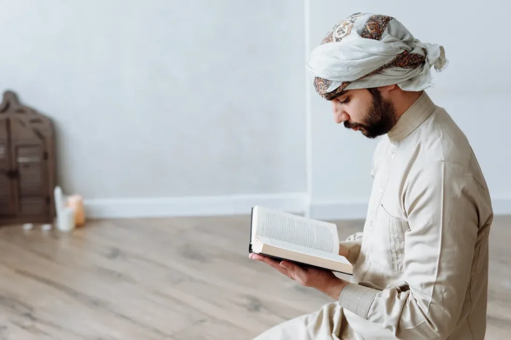 Adult man reading the Quran at home