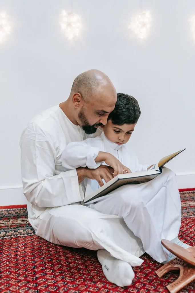 Father and son reading the Quran together at home
