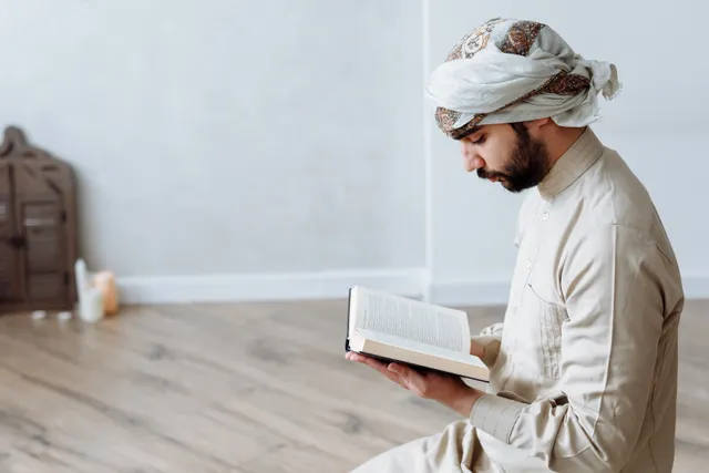 Adult man reading the Quran at home