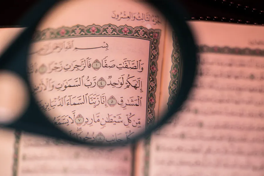 Quran text seen through a magnifying glass