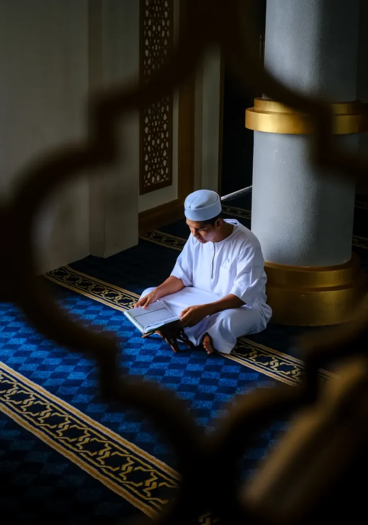 Man reading the Quran in a quiet mosque