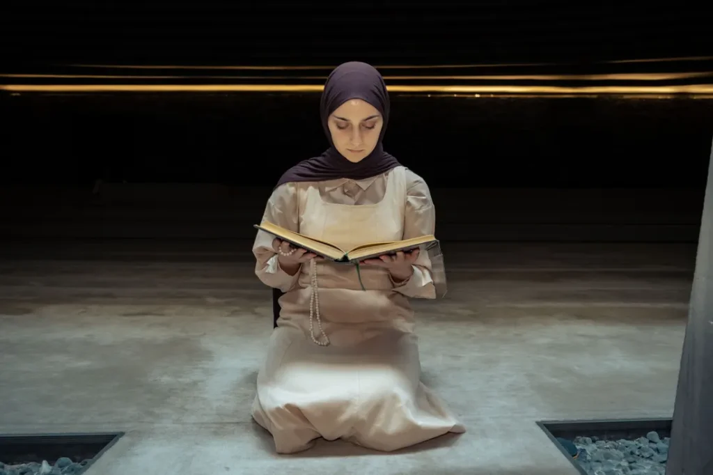 Woman in a hijab reading the Quran